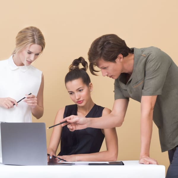 Coworkers collaborating on a project in front of a computer
